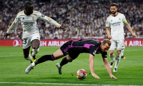 Bayern Munich's Harry Kane hits the deck after a challenge by Real Madrid’s Ferland Mendy.