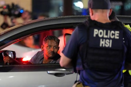 a man in a car talks to a police officer