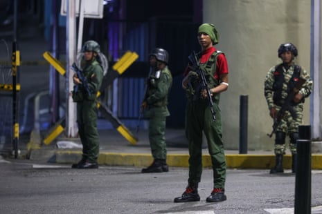 Military personnel guard the perimeter of the Miraflores presidential palace in Caracas, Venezuela, after multiple explosions were reported across the capital.