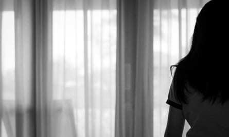 View of the back of an Asian sitting in front of a window