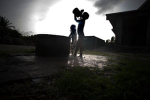 Children bathe in water from a shallow well