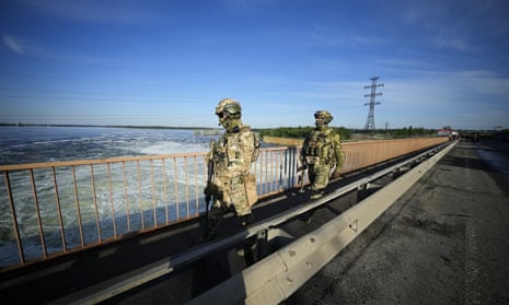 Russian troops patrol the Kakhovka hydroelectric station on the Dnipro River in Kherson region, south Ukraine