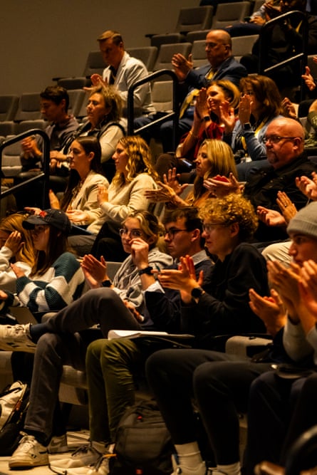 A seated audience clapping.