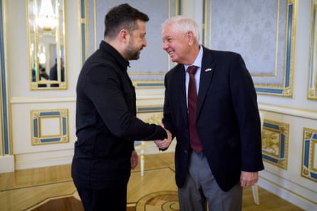 two men shaking hands and smiling