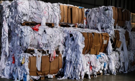 Piles of boxes overflowing with polyester garments