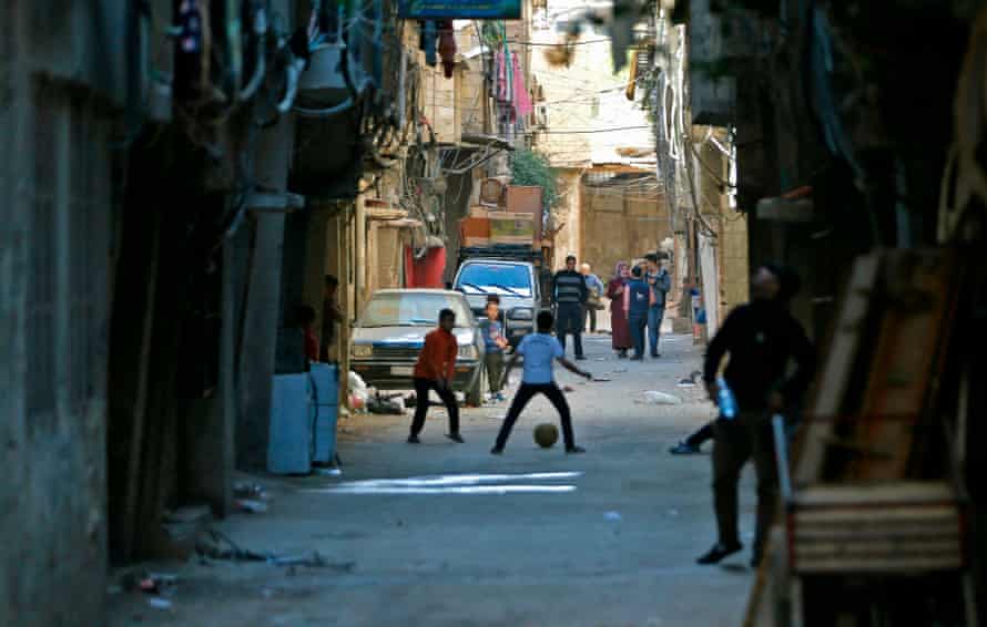 Children play football in a narrow street in Tadamun neighbourhood in the south of the Syrian capital of Damascus, 2018.