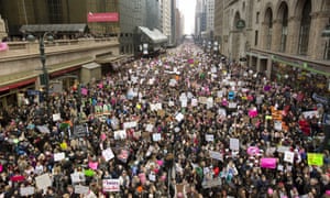 Massive crowds
        march past Grand Central Station on 42nd Street.