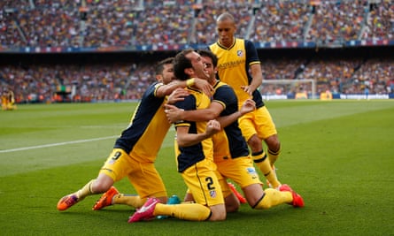 Diego Godín is congratulated by his Atlético Madrid team-mates after his equaliser against Barcelona that won the Spanish title at the Camp Nou in 2014