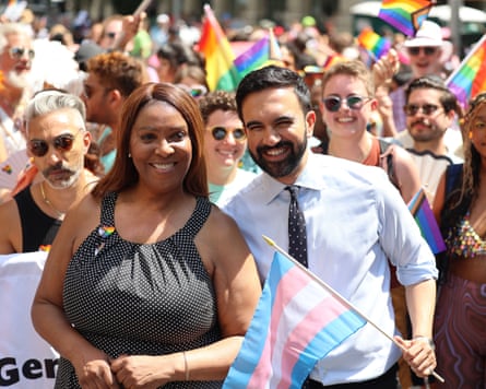 Man and woman, with the man holding a trans flag