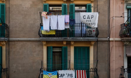 Banners reading ‘No tourist flats’ hang from a balcony in the Barcelona neighbourhood of Barceloneta