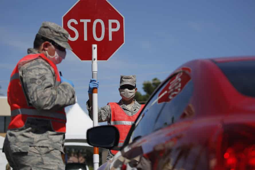 Members of the Nevada Air National Guard work at a drive-thru coronavirus testing site Tuesday, April 28, 2020, in Las Vegas.