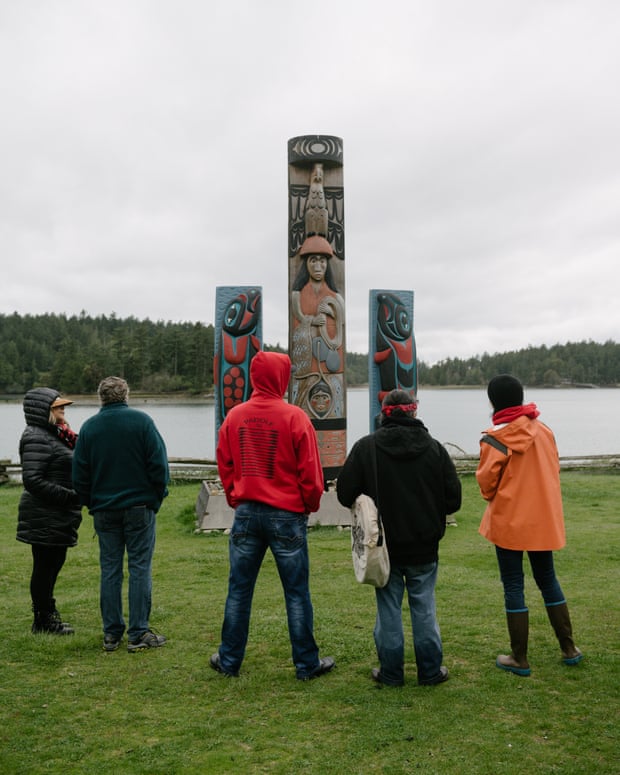 Lummi tribal members wait for hereditary chief Bill James to speak at English Camp on the Puget Sound following a ceremonial feeding of the qwe ‘lhol mechen, commonly known as orcas, Wednesday, April 10, 2019 in Washington.