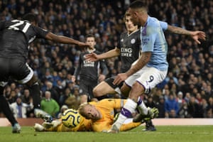 Manchester City’s Gabriel Jesus (right) attempts a shot at goal as Leicester’s goalkeeper Kasper Schmeichel dives on the ground. Manchester City came from behind to win 3-1.