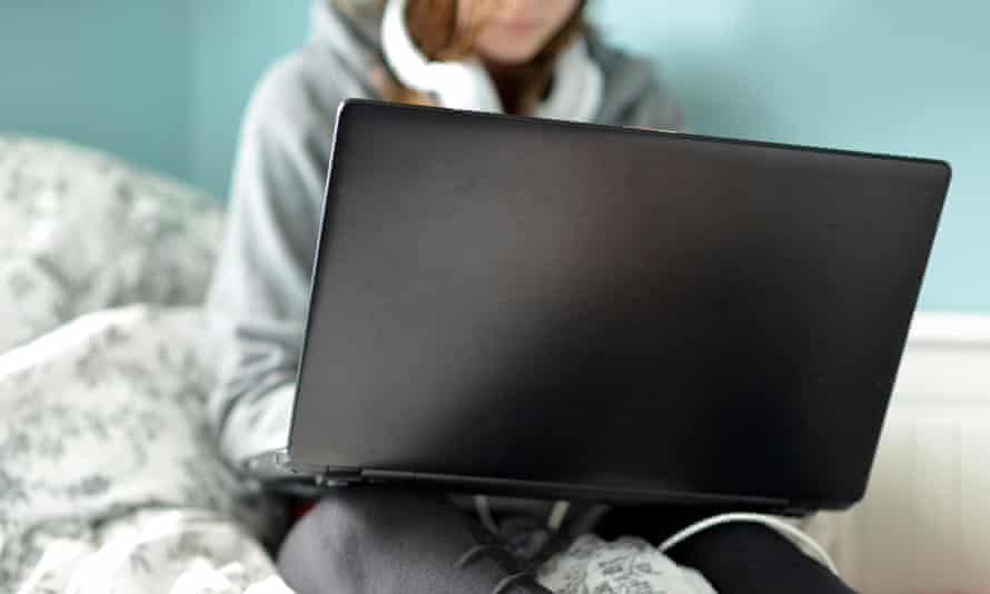Teenage girl on a laptop in her bedroom