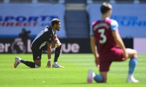 Newcastle United’s Joelinton kneels in support of the Black Lives Matter campaign before the match.