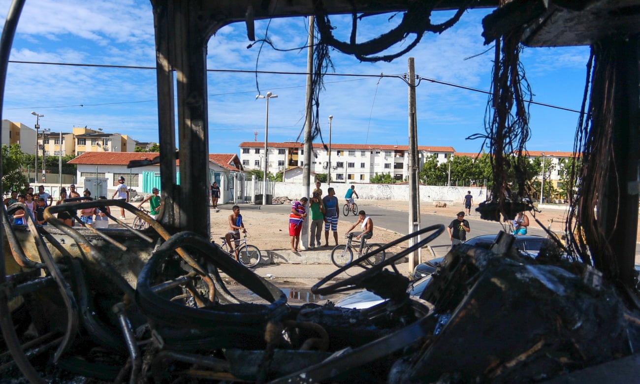 The remains of a burnt-out vehicle after an attack in Fortaleza
