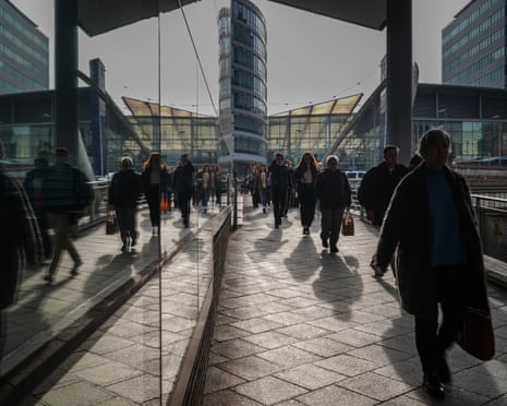Commuters making their way to work in Manchester City centre.