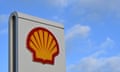 Yellow and red shell logo on white sign, with blue sky in the background
