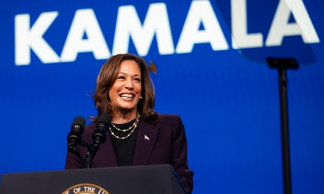 Kamala Harris smiles in front of blue background