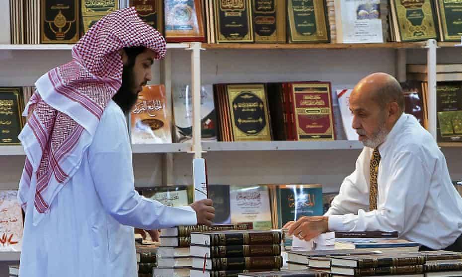 A customer and a stall owner in conversation at the Kuwait international book fair in Kuwait City, in 2019.