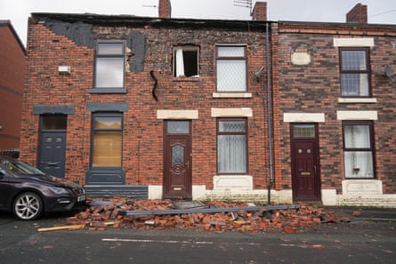 A house and car in Ashton-under-Lyne that were damaged by Storm Franklin in February last year.