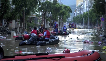 Rescuers evacuate residents in dinghies from flooded streets