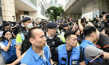 Police outside the West Kowloon magistrates court in Hong Kong, after a court found 14 people guilty of subversion in the prosecution of the ‘Hong Kong 47’.