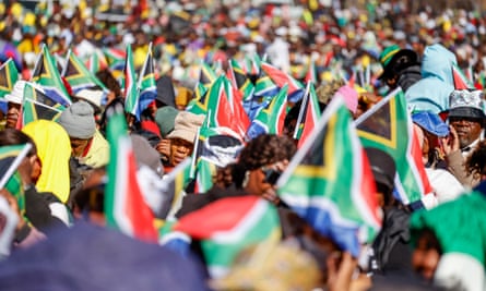 People wave flags in a crowd
