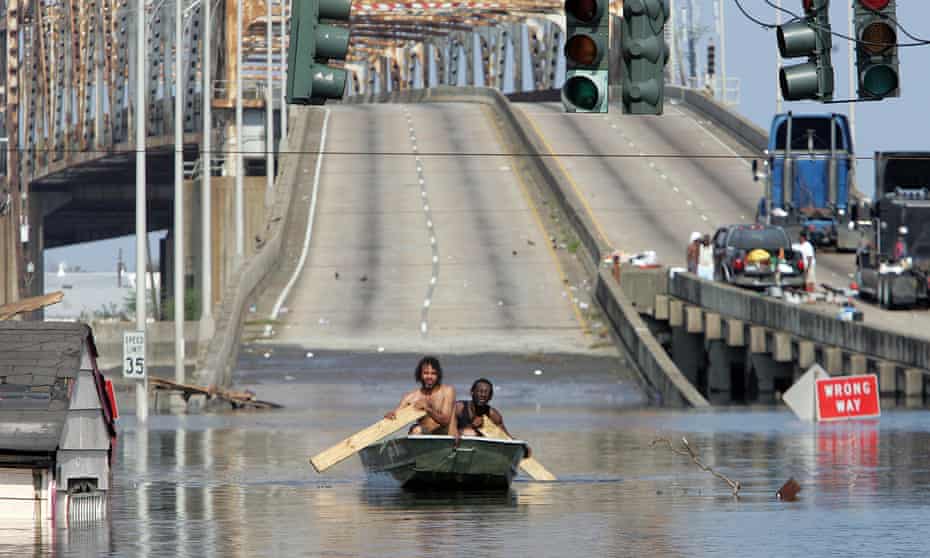 Two men paddle in high water after Hurricane Katrina