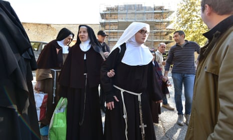 Nuns leave the centre of Norcia on Sunday after the earthquake hit