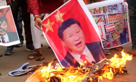Activists burn posters of Chinese President Xi Jinping after Indian soldiers were killed in a fatal face-off at the border with Chinese soldiers in Galwan Valley 