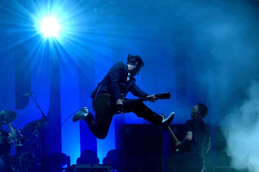 Phil Jamieson, frontman of rock band Grinspoon, jumps on stage during the One From The Heart benefit concert on May 15, 2022 in Lismore, Australia.