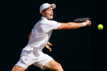 Arthur Fery eyes the ball as he stretches for a backhand return.