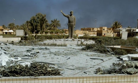 Statue of Saddam Hussein in front of a bombed-out communication centre in Baghdad in March 2003.