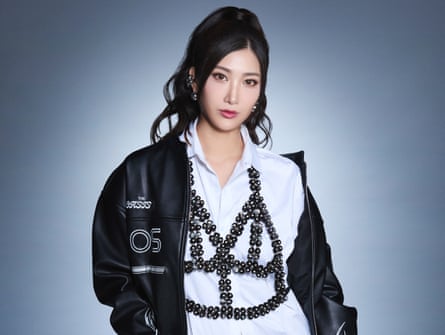 Ejae in white shirt and dark jacket.