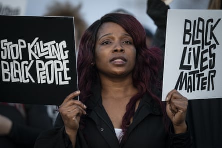 A demonstrator protests the fatal shooting of Daunte Wright outside the Brooklyn Center police department on 16 April.