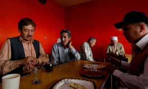 Hazara men eat breakfast at a restaurant in Mariabad