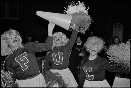 Men dressed as cheerleaders with the letters on their sweaters spelling out F-U-C