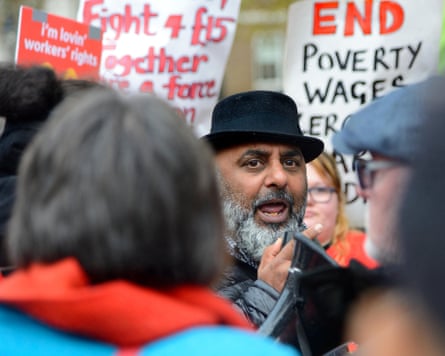Rehman among people carrying banners, one with the words ‘End poverty wages’