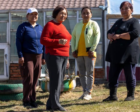 Four Mongolian women look unsmiling to camera.