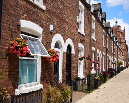Pretty street of brick terrace houses with flower baskets
