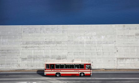 A bus drives past a seawall in Yamada, Iwate prefecture, Japan, in 2018.