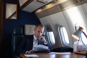 Dominic Raab reading on a plane