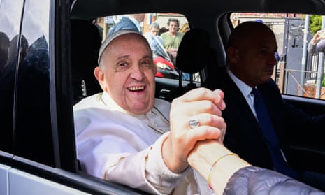 Pope Francis shakes hands with a wellwisher after leaving Gemelli hospital in Rome.