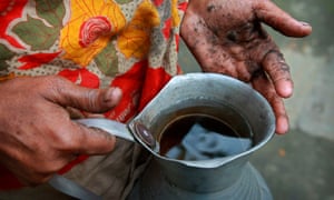 Hanufa Bibi, 45, holds a vessel of contaminated water from a well in her village in Chandipur, about 120km east of Dhaka, in Bangladesh.