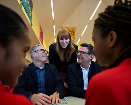 Keir Starmer, Angela Rayner, and Greater Manchester Mayor Andy Burnham meet with schoolchildren during a visit to a primary school in Ashton-under-Lyne, Greater Manchester,