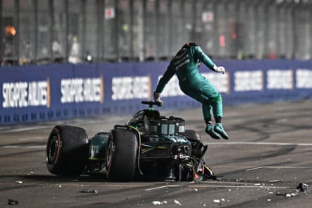 Aston Martin’s Canadian driver Lance Stroll jumps out of his car after crashing during the qualifying session of the Singapore Formula One Grand Prix night race at the Marina Bay street circuit in Singapore, 16 September