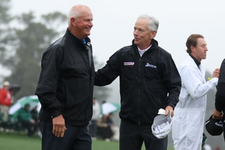 Larry Mize of the United States hugs Sandy Lyle of Scotland on the 18th green during the continuation of the weather delayed second round of the 2023 Masters Tournament.