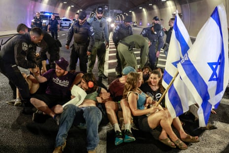 Israeli police remove people blocking traffic in a tunnel, as protesters took to the streets across Israel on 17 August, calling for an end to the war in Gaza and a deal to release hostages.