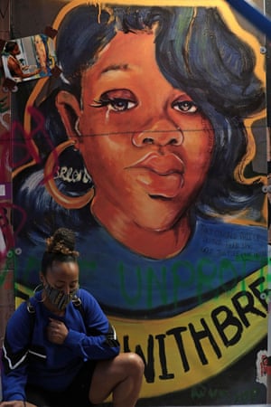 Chanel DaSilva poses in front of a Breonna Taylor mural at Black Lives Matter Plaza in Washington.